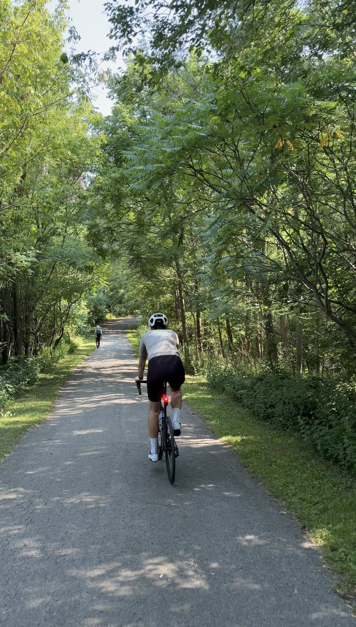 A rider on the tree-covered Lower Don Valley Trail through the ravine