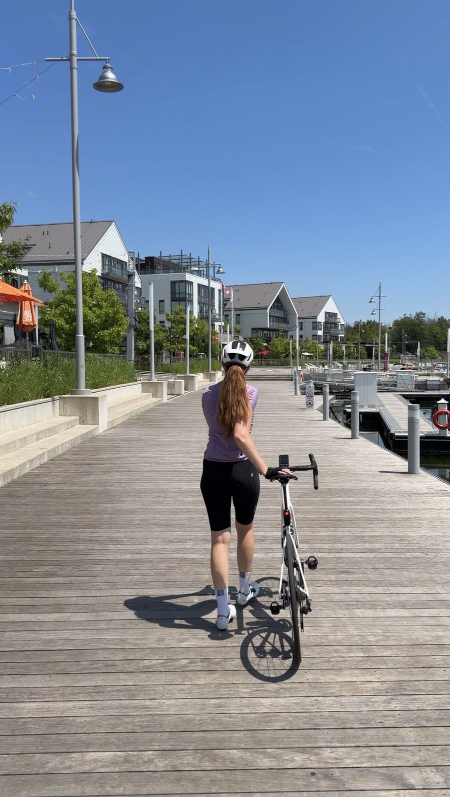 Bailey walking her bike along the Friday Harbour marina boardwalk