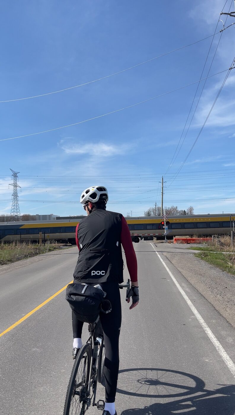 Stopped at a rail crossing as a train passes on the way east