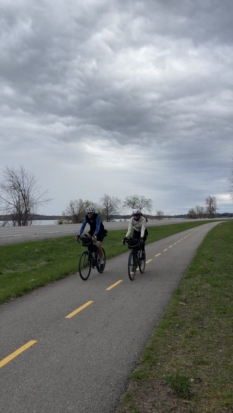 Francis and Bailey riding the paved Thousand Islands Parkway trail beside the St Lawrence River